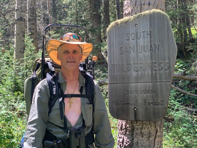 Hunting remote wilderness areas - Author standing next to the South San Juan Wilderness Area sign.