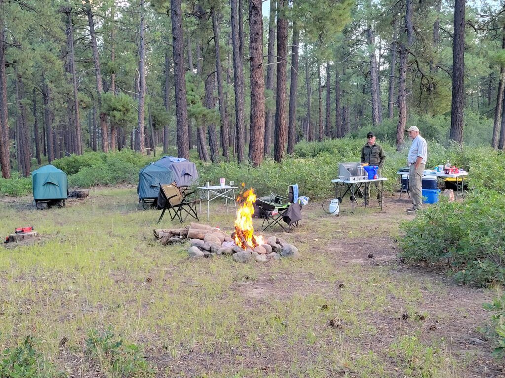 Tentcots and a campfire at our DIY hunting camp setup