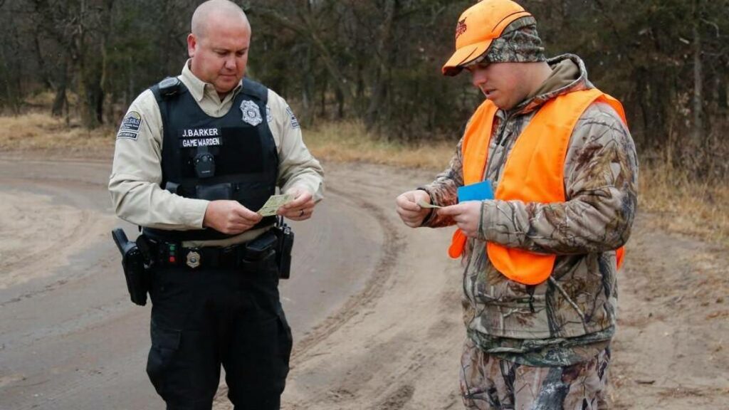 Game warden checking a hunters license