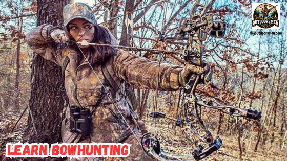 Learn the art of bowhunting featured image showing a lady bowhunter in full camo, and at full draw ready to take the shot.
