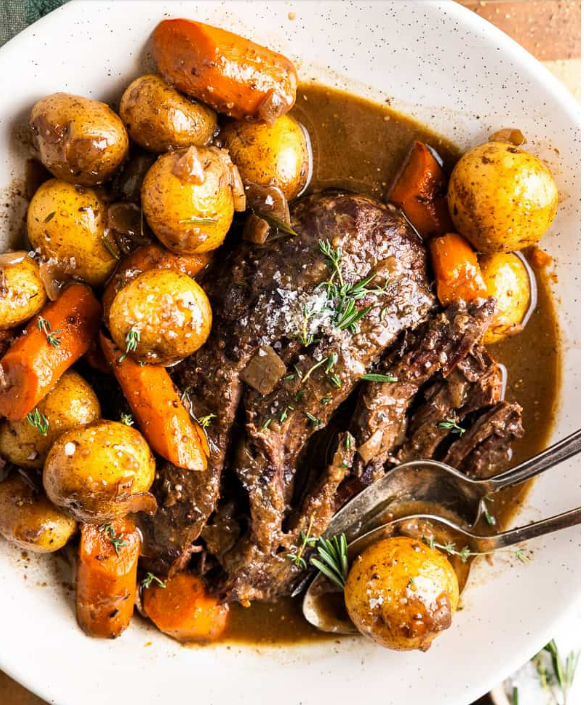 Venison Pot Roast on a plate with potatoes and carrots.