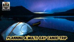 How to plan a multi-day canoe or kayaking trip featured image showing a tent with a light glowing inside next to a lake with a canoe on the bank under a moonlit sky.