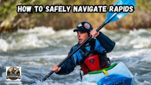 How to Safely Navigate Rapids featured image showing a man in his kayak on a river attempting to run the rapids.