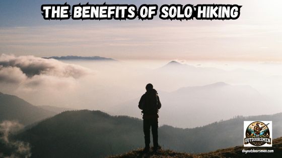 Benefits of Solo Hiking featured image showing a hiker standing on top of a mountain looking over a cloud shrouded valley.